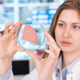 woman examining salami in lab